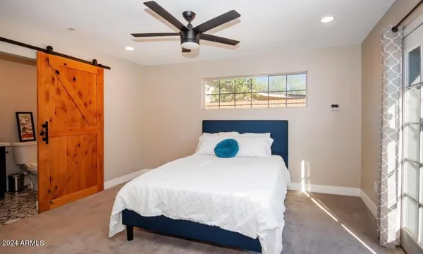 a bedroom with a bed and a window