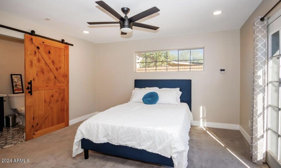 2023 West Windsor Avenue Phoenix, AZ 85009 - Photo 8 of 12 a bedroom with a bed and a window