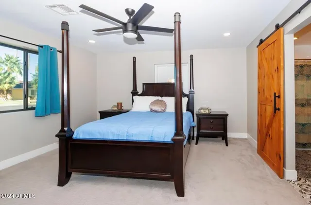 a bedroom with a bed and a table