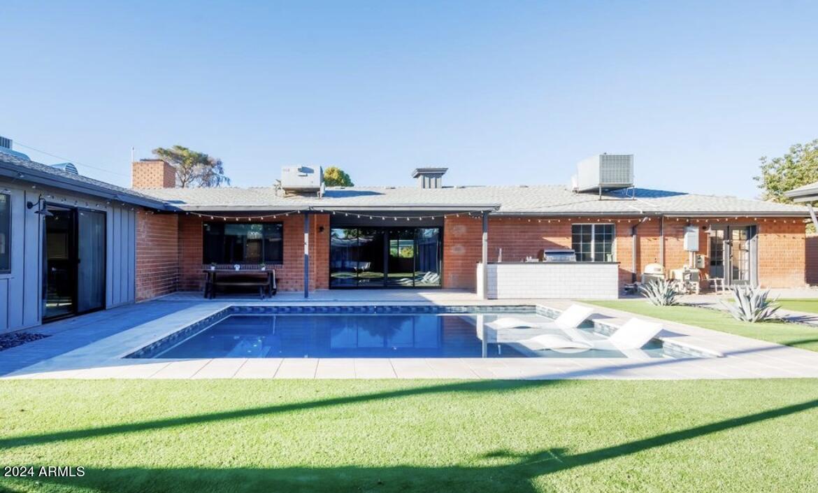 2023 West Windsor Avenue Phoenix, AZ 85009 - Photo 10 of 12 a view of a house with swimming pool and furniture