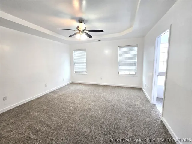 an empty room with a empty space and a ceiling fan