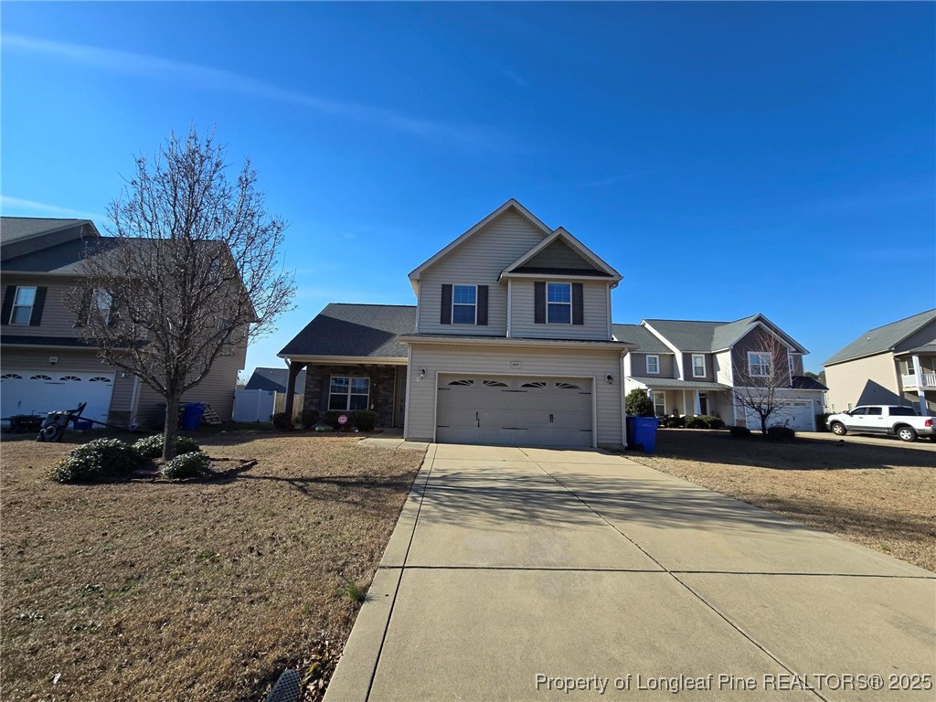 2816 Deepwater Court Fayetteville, NC 28306 - Photo 3 of 34 a front view of a house with a yard and garage