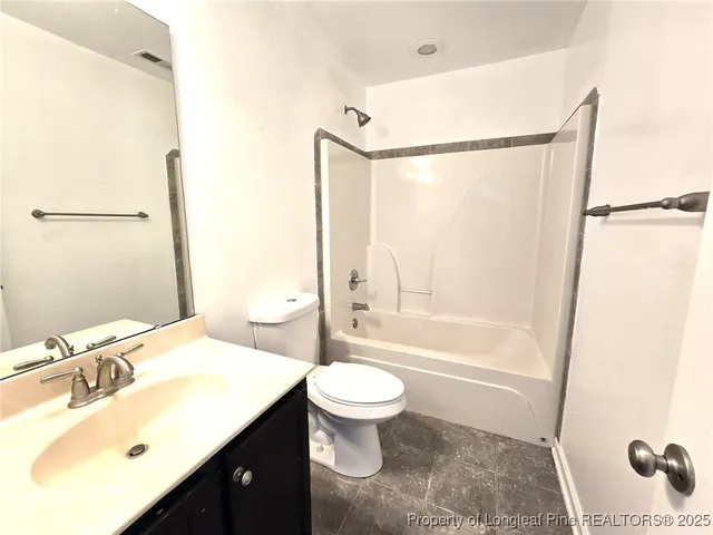a bathroom with a sink toilet a mirror and shower