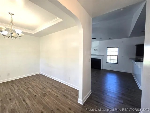 a view of a room with wooden floor and a flat screen tv
