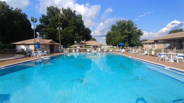 a outdoor view with a sitting space and swimming pool