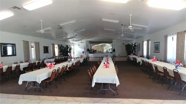 a view of a room with dining table and chairs