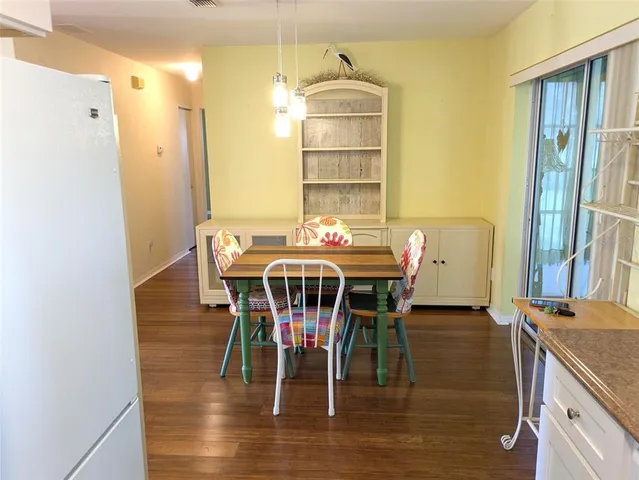 a dining room with furniture window and wooden floor