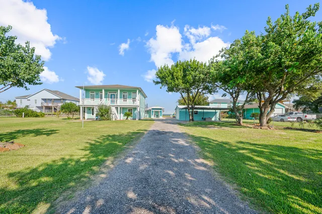 a living room with furniture kitchen view and a large window