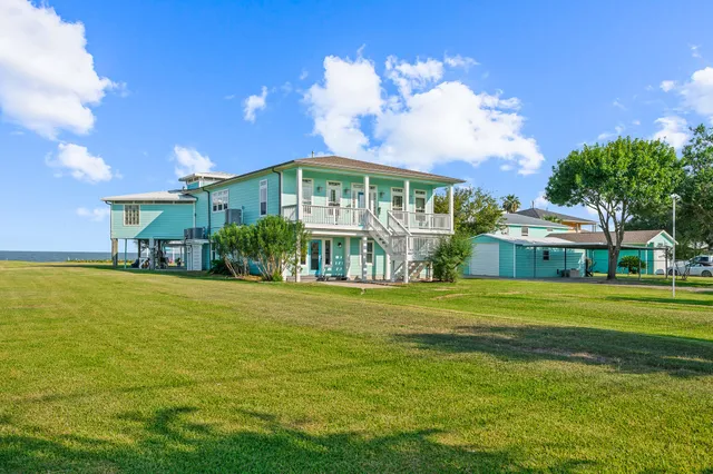 a bathroom with a granite countertop sink a toilet and shower