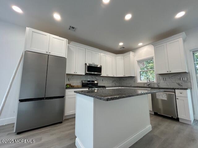 45 Salem Place Cliffwood, NJ 07721 - Photo 4 of 16 a kitchen with stainless steel appliances granite countertop a refrigerator a sink a stove a microwave and white cabinets