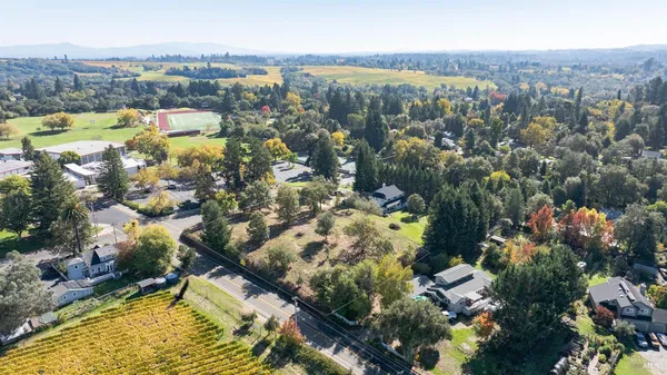a view of a field of grass and trees