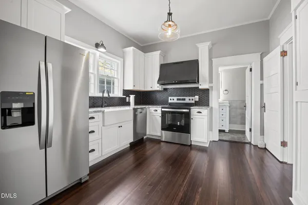 a view of a kitchen with a sink wooden floor and a window
