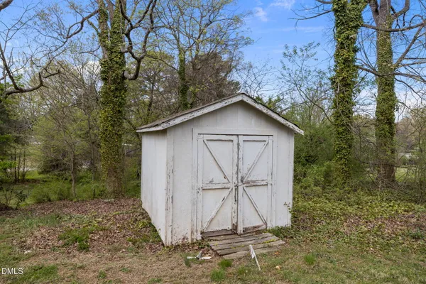 a aerial view of a house with a big yard plants and large trees