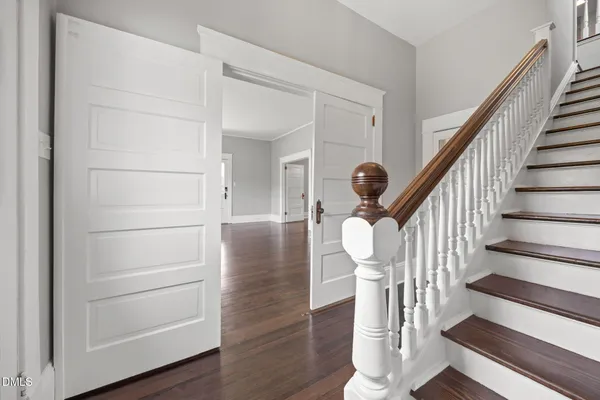 a view of entryway and hall with wooden floor