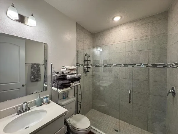 a kitchen with stainless steel appliances kitchen island granite countertop a sink a stove and cabinets