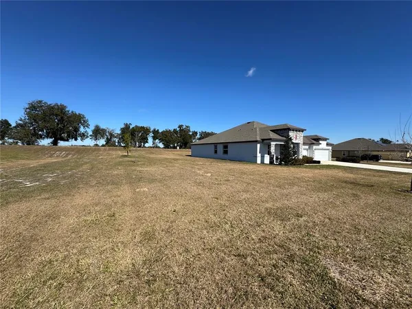 aerial view of a house with a yard