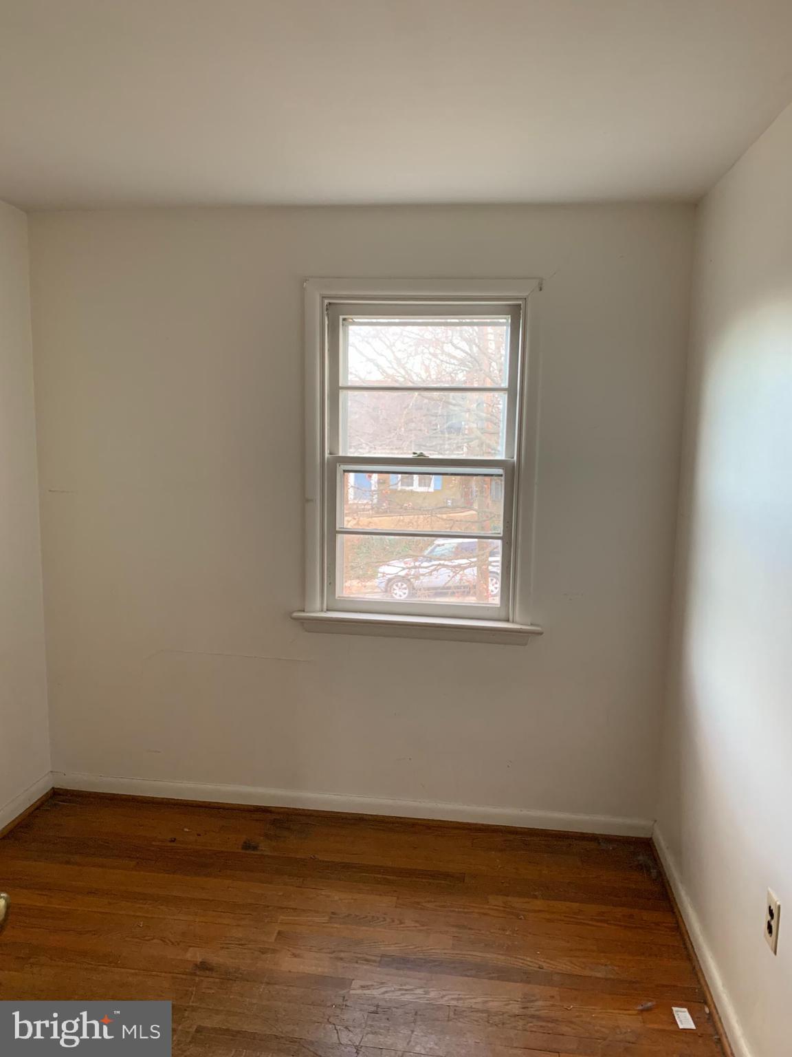 1231 High Street Lancaster, PA 17603 - Photo 12 of 16 an empty room with wooden floor and windows