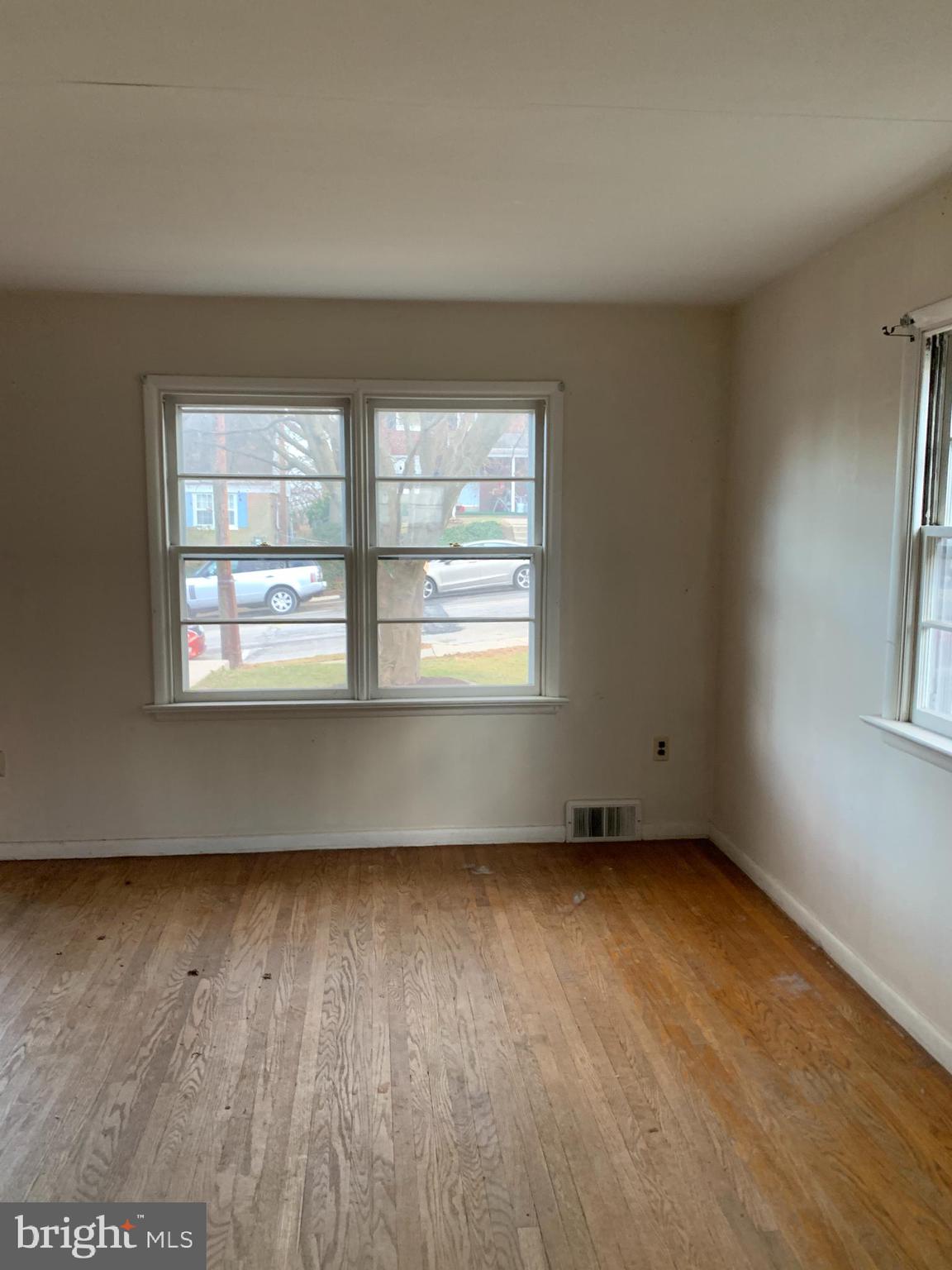 1231 High Street Lancaster, PA 17603 - Photo 4 of 16 an empty room with wooden floor and windows