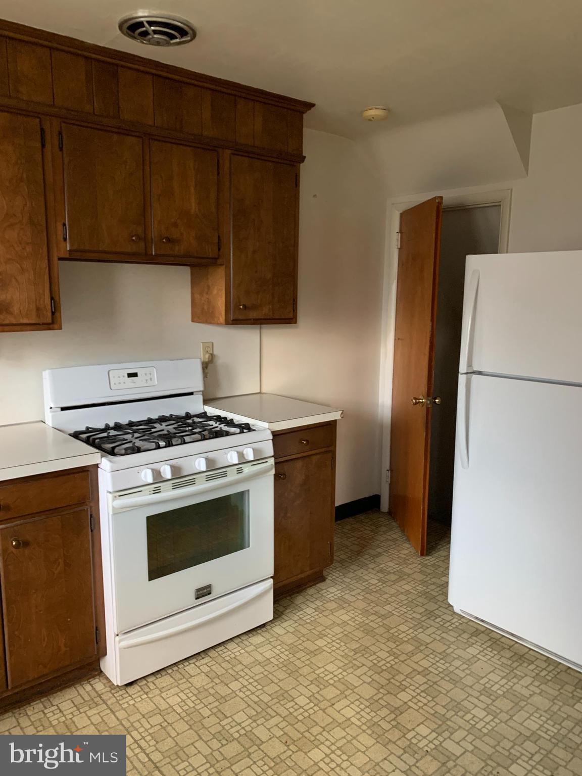 1231 High Street Lancaster, PA 17603 - Photo 7 of 16 a kitchen with a stove and a refrigerator
