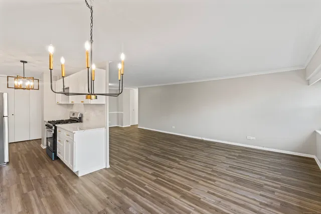 a kitchen with kitchen island a sink and a stove top oven
