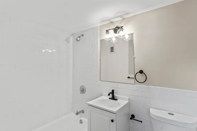 a bathroom with a sink a toilet and a shower