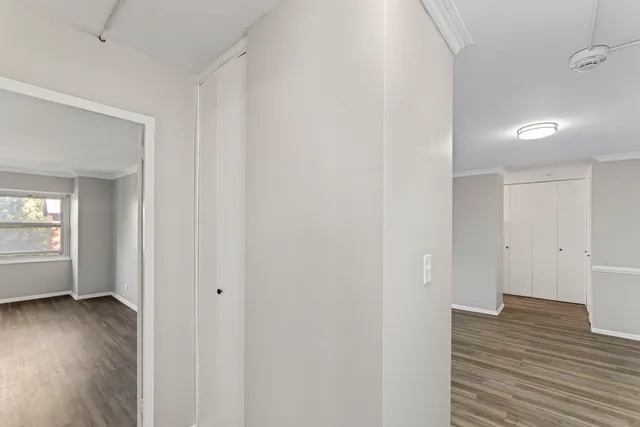 a view of a room with wooden floor and window