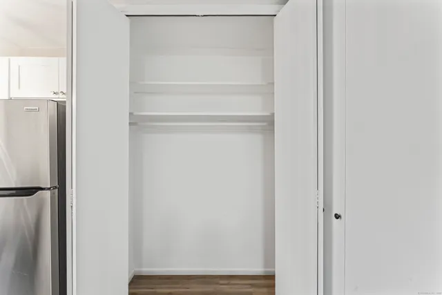 a view of walk in closet with empty racks