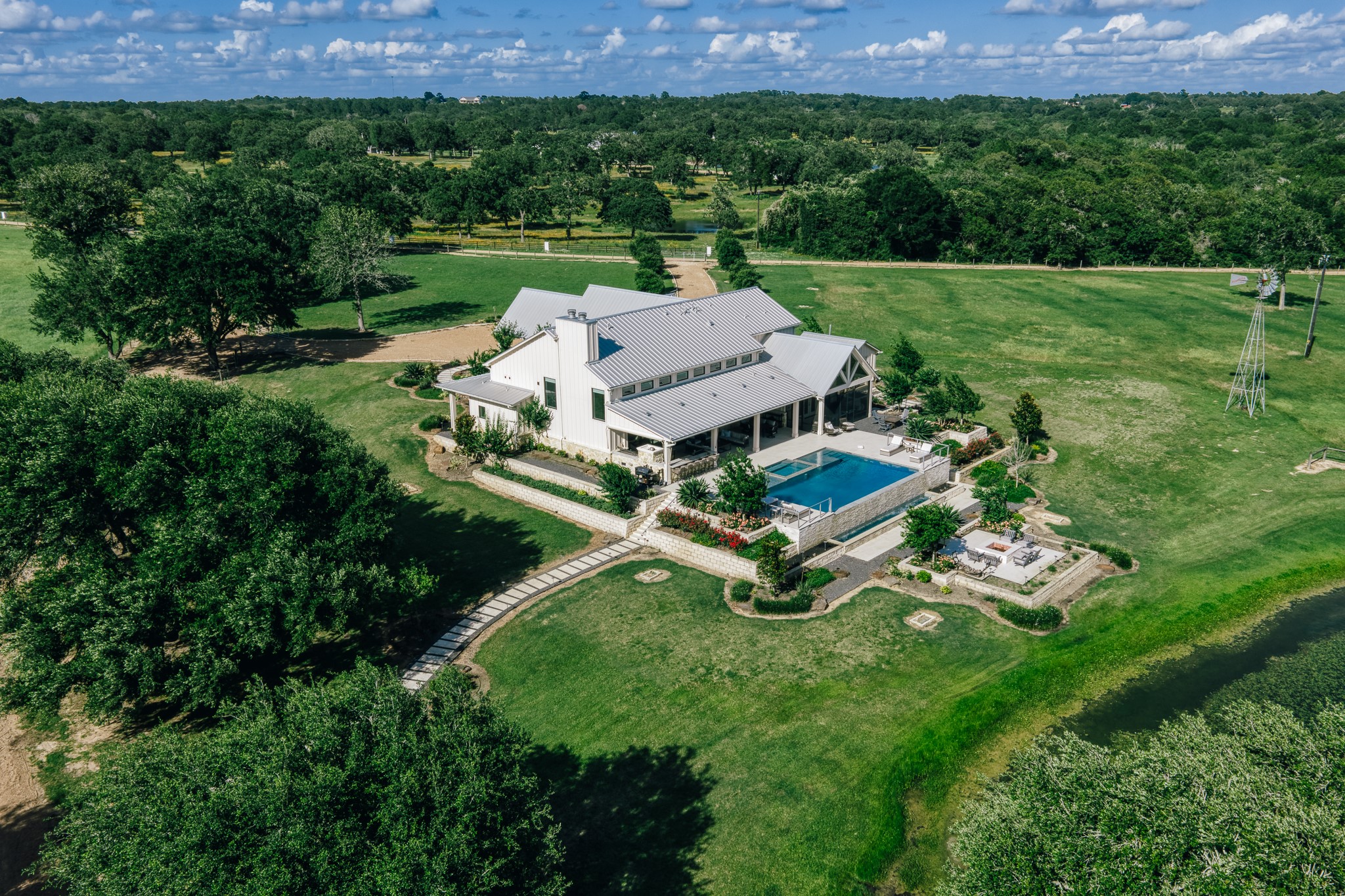1034 Hilbun Road New Ulm, TX 78950 - Photo 45 of 49 An exceptional legacy property showcasing panoramic views, magnificent oak canopies, sparkling lakes, luxury residences, hunting opportunities, a private shooting range, and unforgettable Texas sunsets.