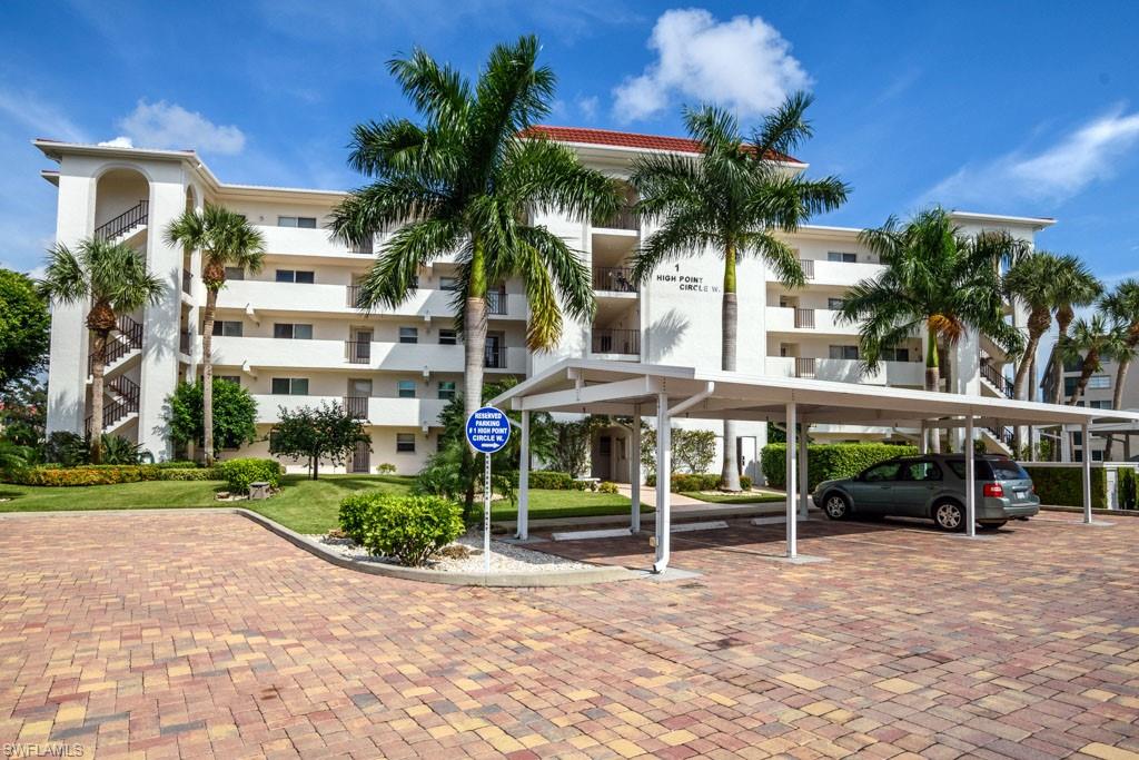 a view of a house with a yard and potted plants