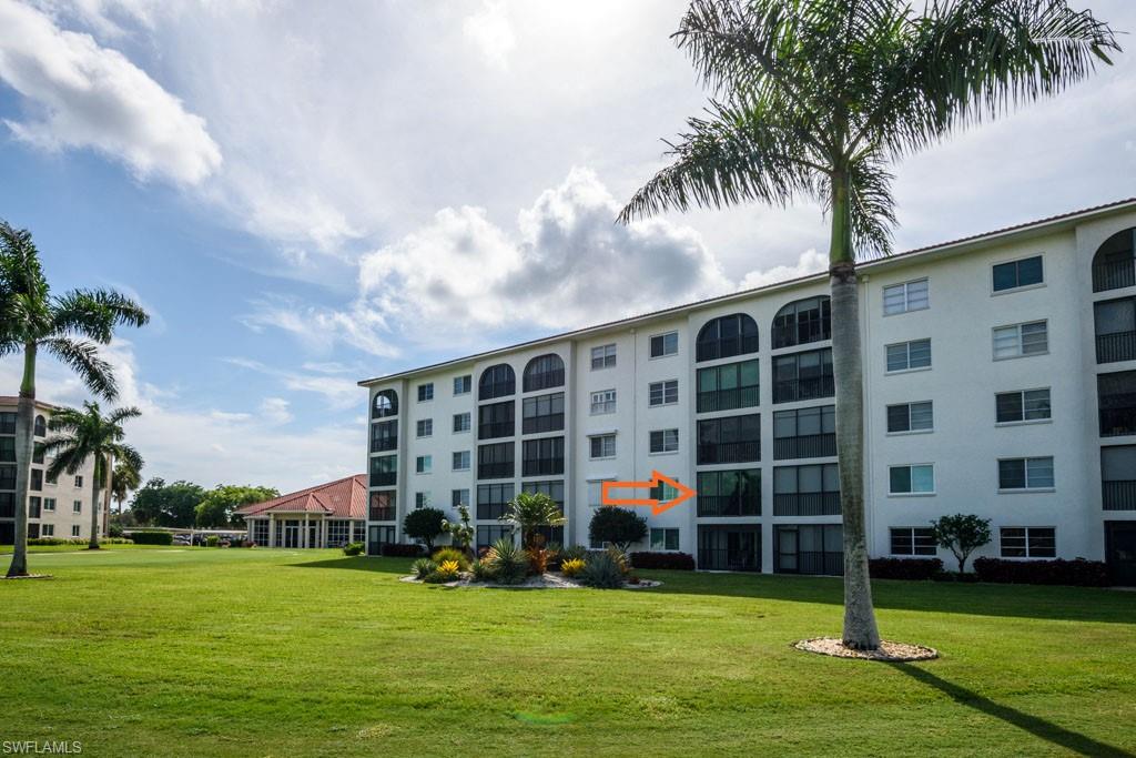 1 High Point Circle West, Unit 203 Naples, FL 34103 - Photo 20 of 31 a view of building with yard