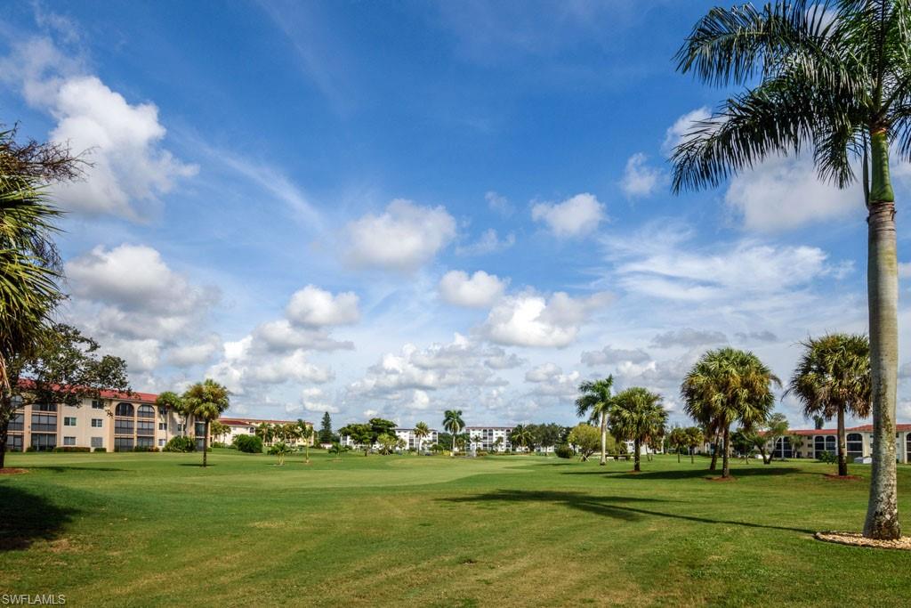 1 High Point Circle West, Unit 203 Naples, FL 34103 - Photo 22 of 31 a garden view with a play ground