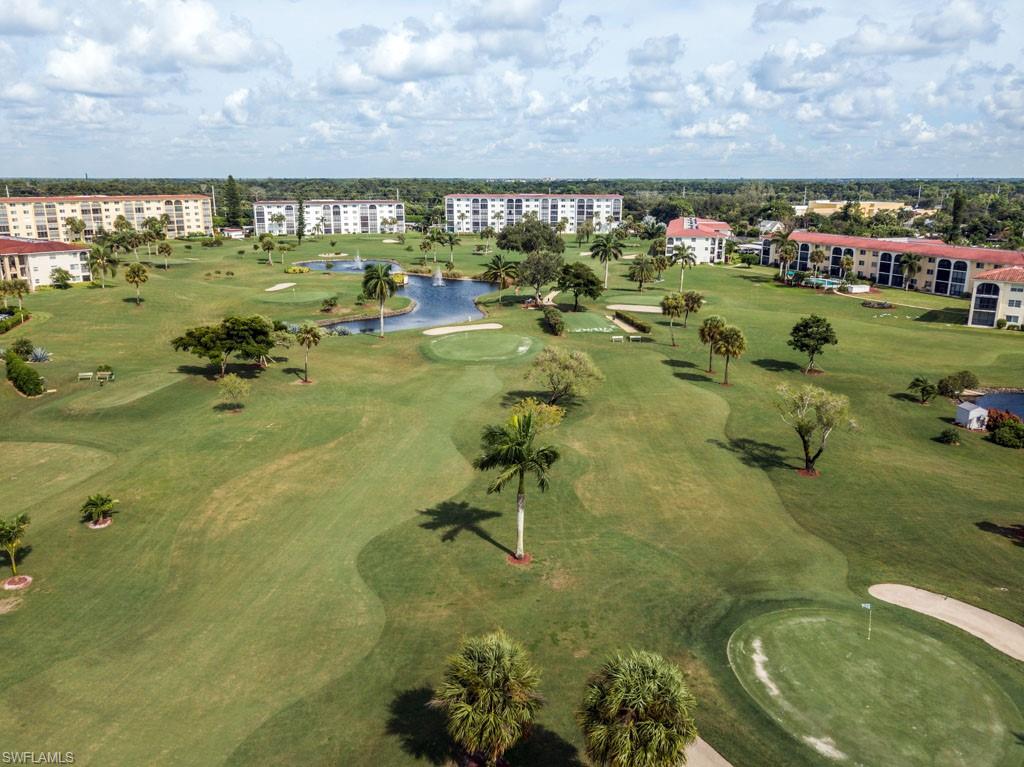1 High Point Circle West, Unit 203 Naples, FL 34103 - Photo 25 of 31 a swimming pool view with a outdoor seating space