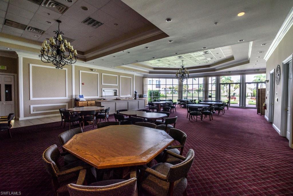 1 High Point Circle West, Unit 203 Naples, FL 34103 - Photo 28 of 31 a outdoor dining space with furniture window and wooden floor