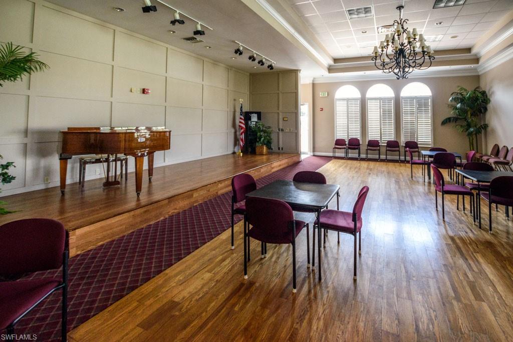 1 High Point Circle West, Unit 203 Naples, FL 34103 - Photo 30 of 31 a view of a dining room with furniture and wooden floor