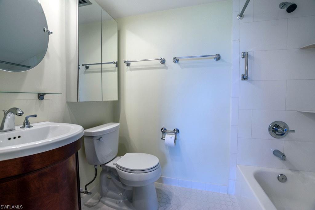 1 High Point Circle West, Unit 203 Naples, FL 34103 - Photo 10 of 31 a bathroom with a sink a toilet and shower