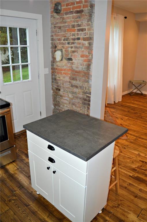 223 Mercer Street Butler, PA 16001 - Photo 7 of 21 Kitchen island for entertaining. More exposed brick.