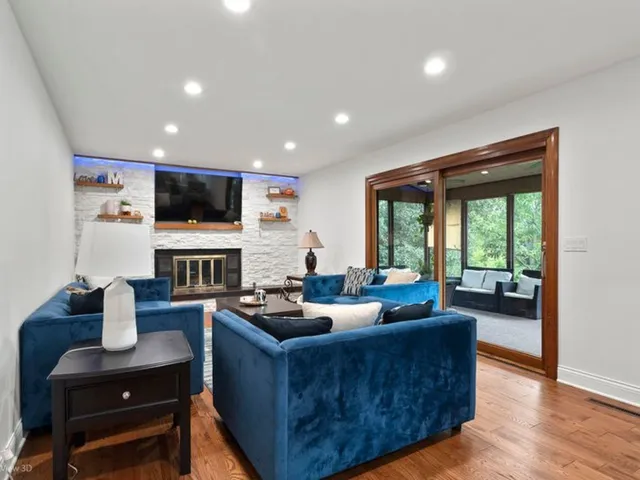a living room with fireplace furniture and a flat screen tv