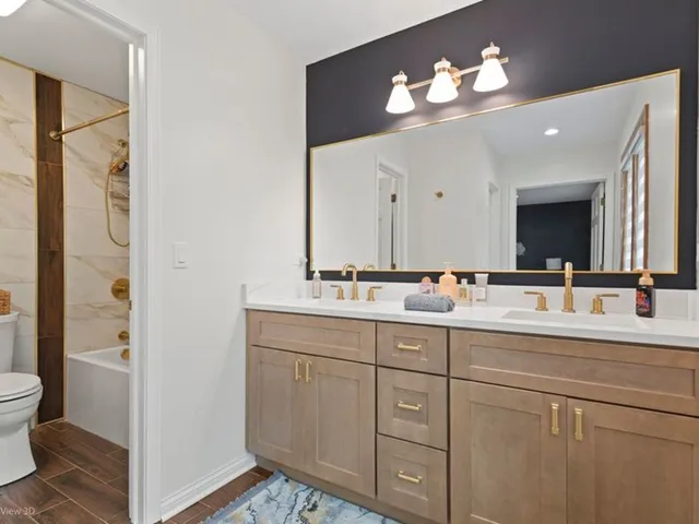 a bathroom with a double vanity sink and a mirror