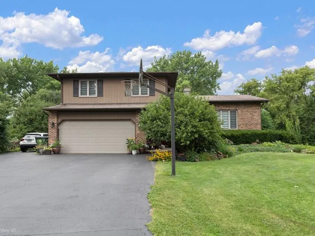 a view of a house with a garden and pathway