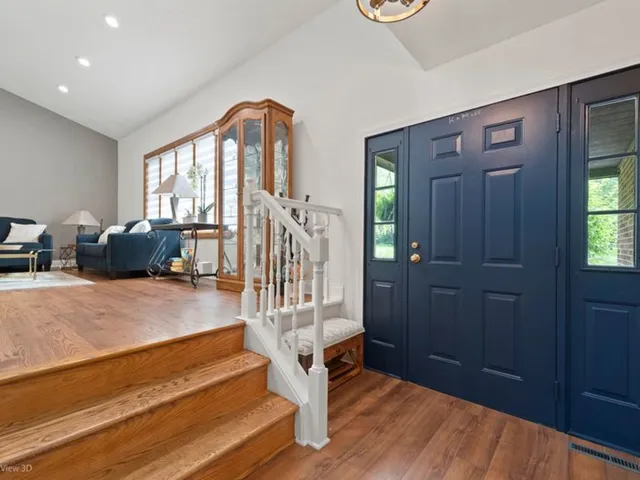 a view of entryway livingroom and hall with wooden floor