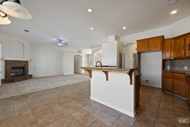 a view of kitchen with furniture and a refrigerator