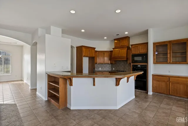 a kitchen with stainless steel appliances granite countertop a stove and a sink
