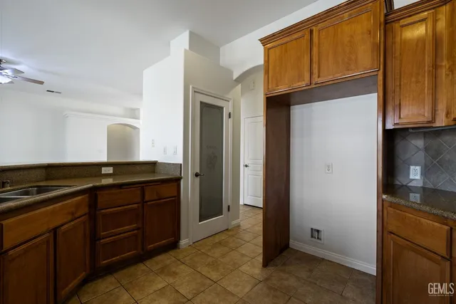 a kitchen with granite countertop cabinets and refrigerator