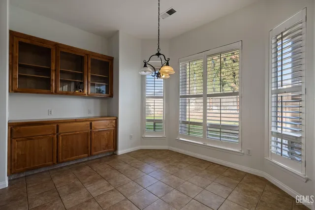 a hallway with windows and chandelier