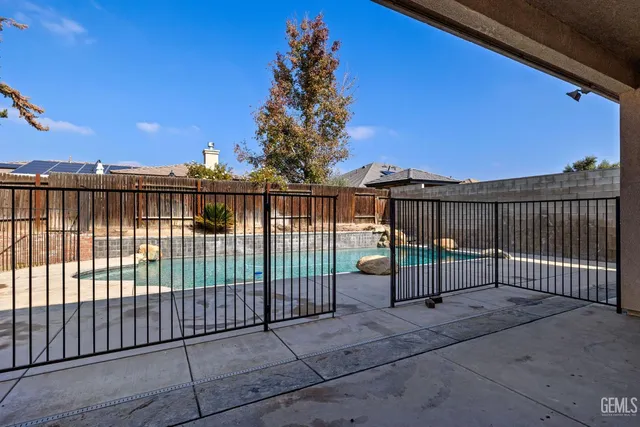a view of a pathway with a wrought fence