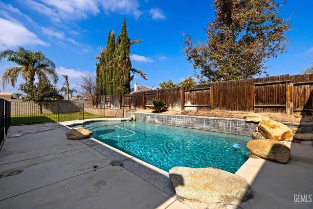 an aerial view of a house with a yard pool windows and chairs