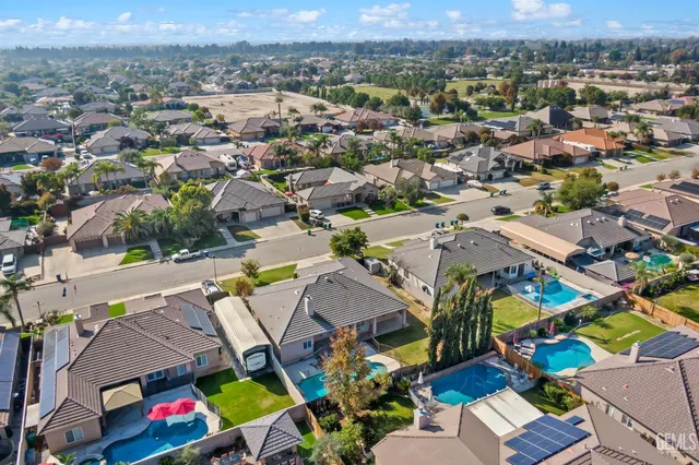 an aerial view of a house with a yard patio and furniture