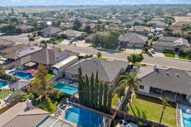 a view of a swimming pool with an outdoor seating and a garden