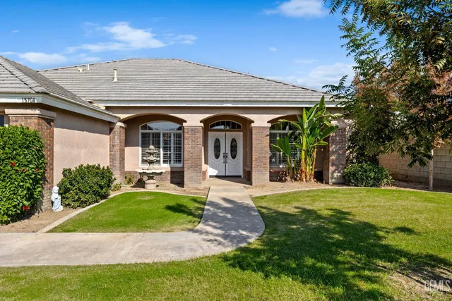 a front view of a house with a yard and porch