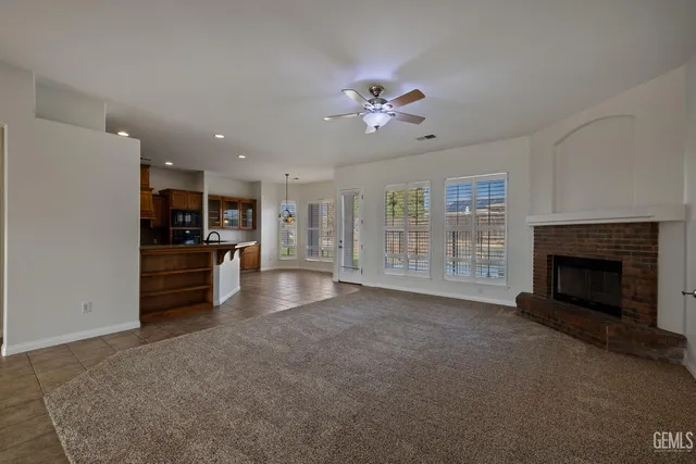a view of a livingroom with furniture a fireplace and window